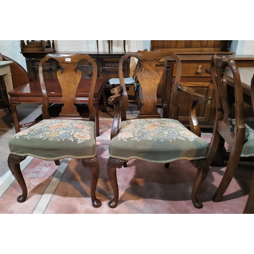 619 - An early/mid 20th century set of 6 (4 + 2) walnut dining chairs with shaped splats and overstuffed n... 