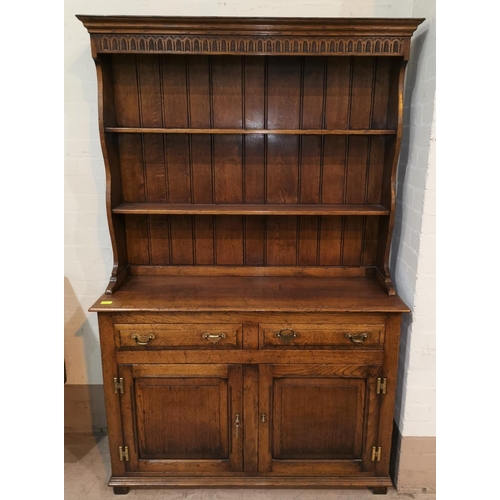 654 - A golden oak Welsh dresser in the style of Titchmarsh & Goodwin with double cupboard and 2 drawers