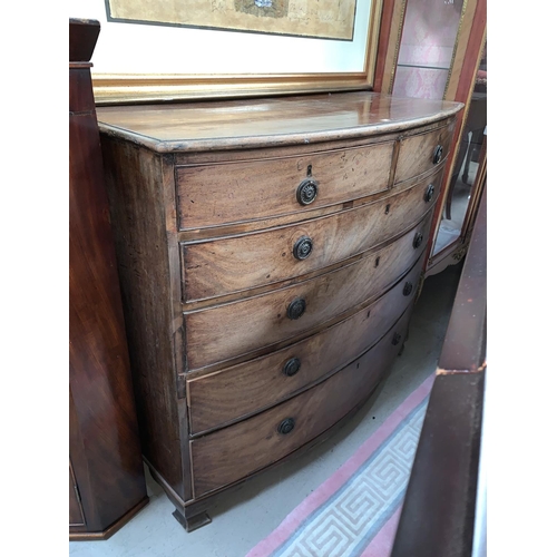 647A - A Georgian style mahogany bow front chest of 4 long and 2 short drawers, ring handles and bracket fe... 
