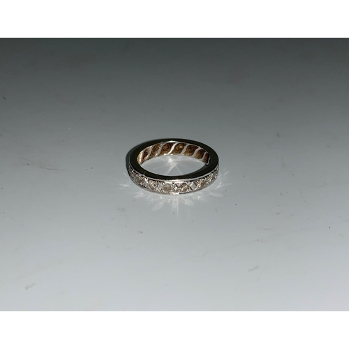 127 - A diamond set eternity ring in white metal, 18 stones, unmarked