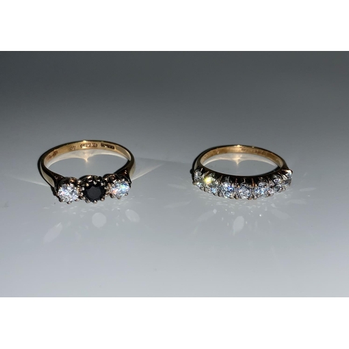 110 - A 9 carat hallmarked gold 3 stone ring  set sapphire and diamond simulant; a similar half eternity r... 
