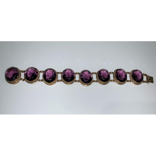 134 - An Edwardian gold plated bracelet set 8 amethyst coloured oval stones
