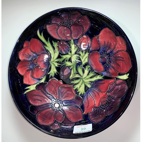 66 - A Moorcroft circular fruit bowl, anemone pattern, impressed and signed, diameter 26 cm