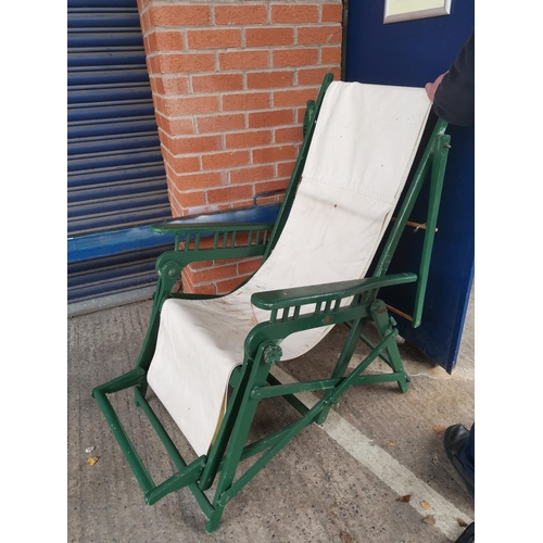 415 - A late 19th/early 20th century patented folding sunchair with cover, green painted