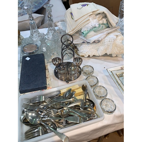 72a - A glass dressing table set; a selection of silver plated cutlery; a selection of table linen; other ... 