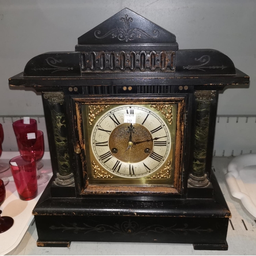 217 - A mantel clock in ebonised wood architectural case, with brass dial and striking movement; an early ... 