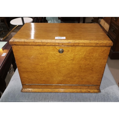 220 - An Edwardian golden oak writing box, with foldout fall front and fitted interior