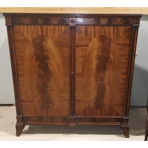 341 - A Georgian style figured mahogany side cabinet with cluster pillars and 2 oval panel doors, on brack... 