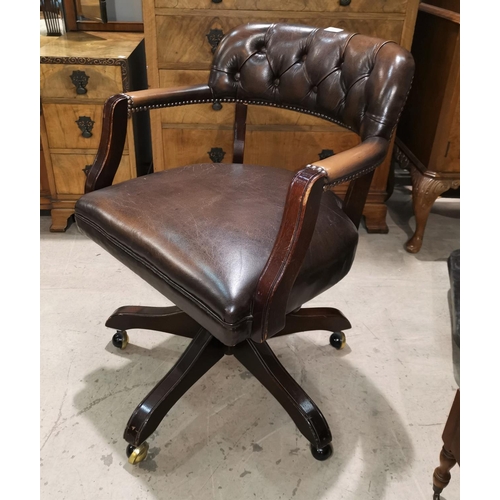 345 - A period style office swivel armchair, tub shaped and upholstered in brown hide