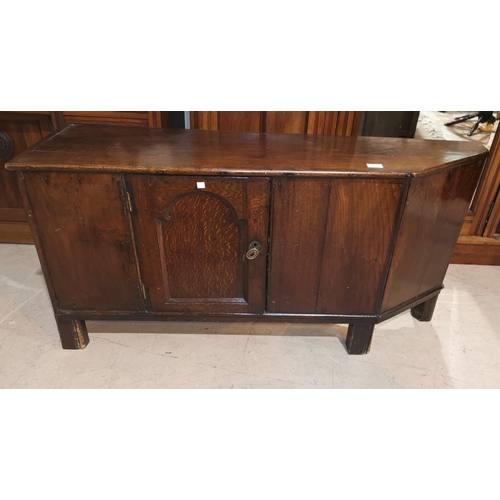 347 - An 18th century oak country made low side cabinet with single door and canted end