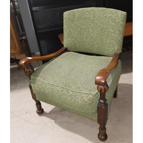 349 - A 1930's oak low seat nursing chair in green moquette
