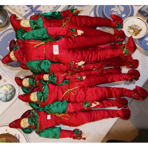 41 - Seven large and 3 small jester dolls in red and green costume