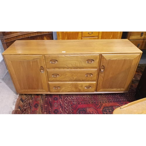 319 - An Ercol elm low sideboard of 2 cupboards and 3 drawers