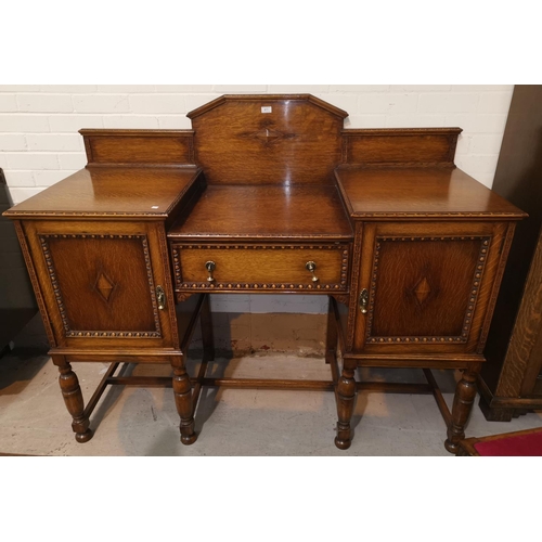 471 - A 1930's golden oak dining suite comprising large draw leaf table, 4 chairs and sideboard of 2 cupbo... 