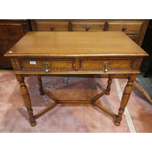 473 - A 1930's golden oak side table with 2 frieze drawers