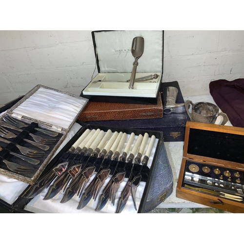 132 - A fitted box with scientific weights; etc.; a selection of EPNS cutlery, boxed