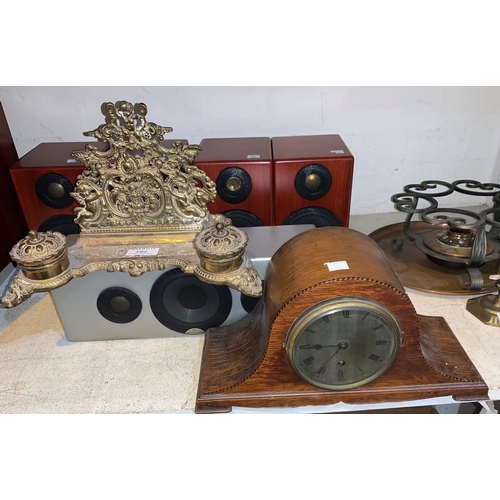 162 - A brass desk organiser with letter rack and inkwell; an oak cased clock by Finnigan's of Manchester