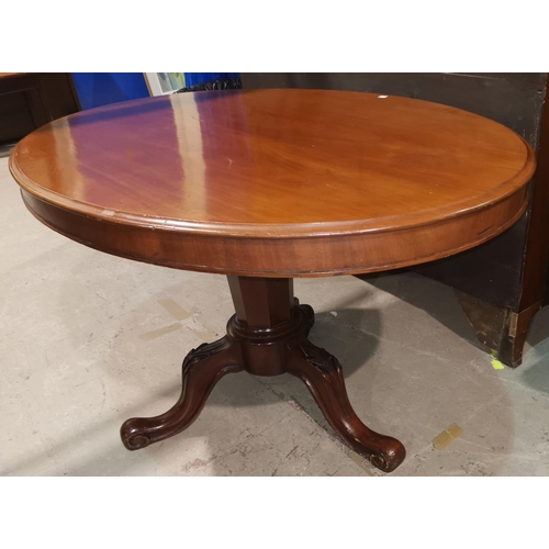 305 - A Victorian mahogany tea table with oval tilt top on octagonal column and 3 carved splay feet