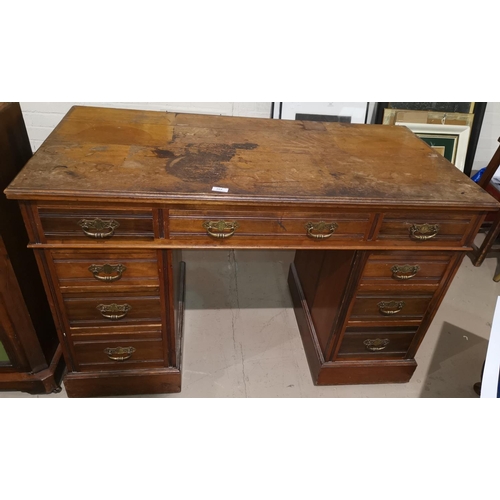 384 - An Edwardian walnut kneehole desk on twin pedestal with 3 frieze and 6 pedestal drawers