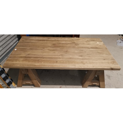 444 - A large rustic coffee table with rectangular top, on trestle base