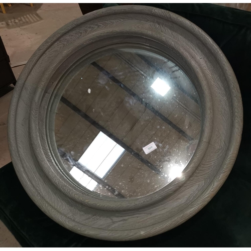 446 - A circular wall mirror in heavy grey stained wooden frame; a pine framed rectangular mirror
