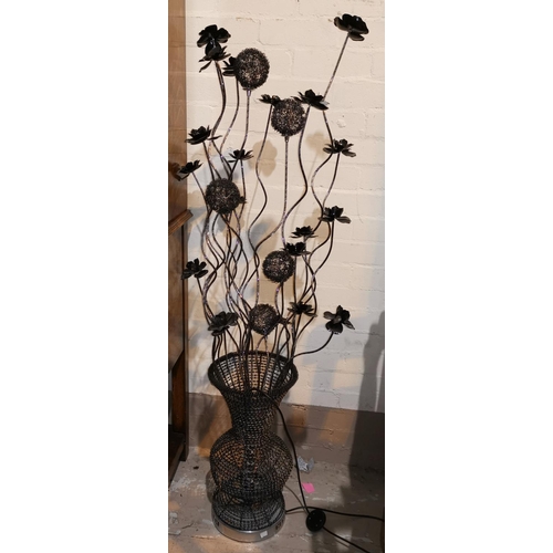 449 - A brushed metal uplight; a metal sculpture flowering plant