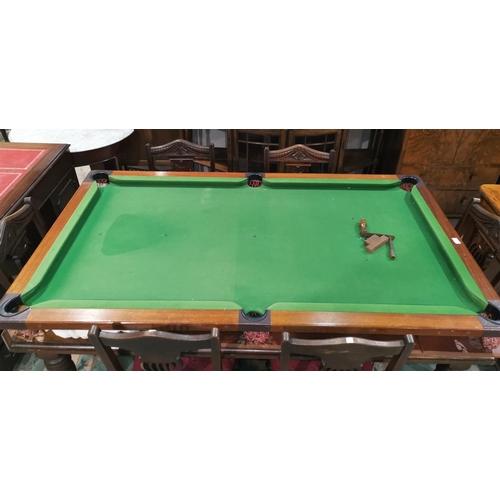 348 - A quarter size snooker table in mahogany with folding trestles, cues, balls and accessories
