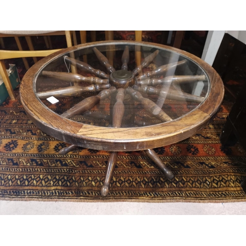 411 - A 'ship's wheel' coffee table with circular glass top