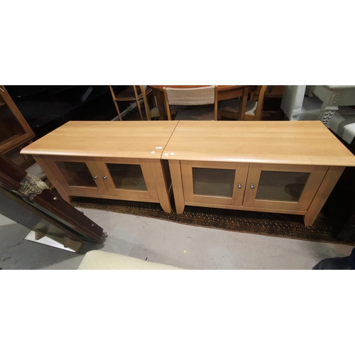 477 - A modern lightwood low cupboard/TV stand; a similar cabinet