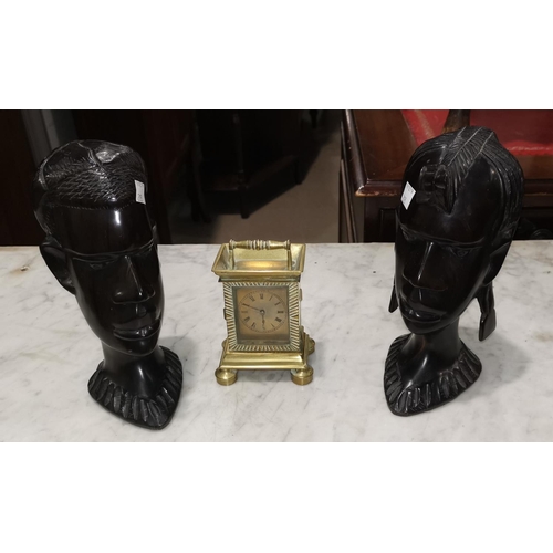 203 - A pair of African carved hardwood busts, 21 cm; a quantity of table linen; a carriage clock  with 19... 