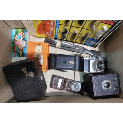 214 - An early Leica light meter; various cameras and collectables