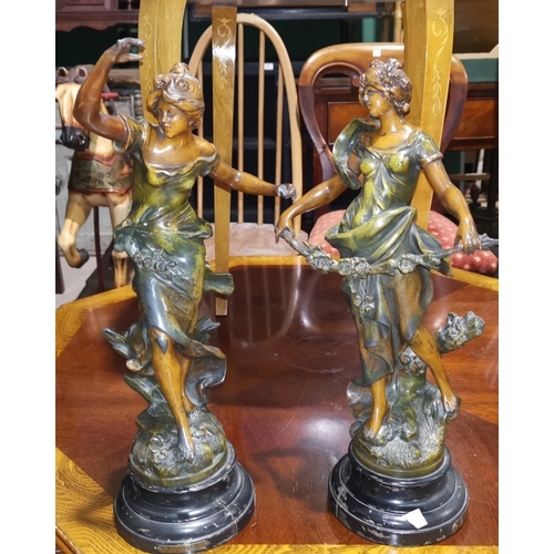 294B - An Art Nouveau period pair of patinated spelter figures of young women after Auguste Moreau, impress... 