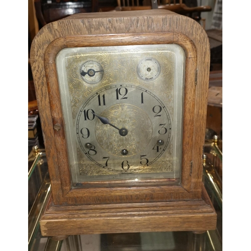 294C - An edwardian oak cased mantel clock with silvered dial and chiming movement