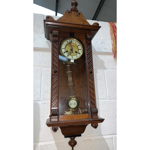 216 - A walnut cased Vienna wall clock with spring driven striking movement