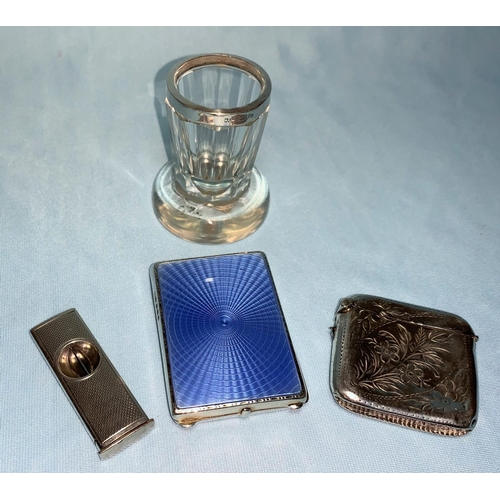 249 - A  blue enamelled silver matchbook holder, Birmingham 1929; a silver vesta case; cigar cutter; a vas... 