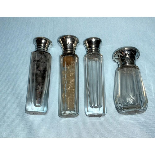 251 - Four cut glass scent/salt bottles with enamelled silver tops