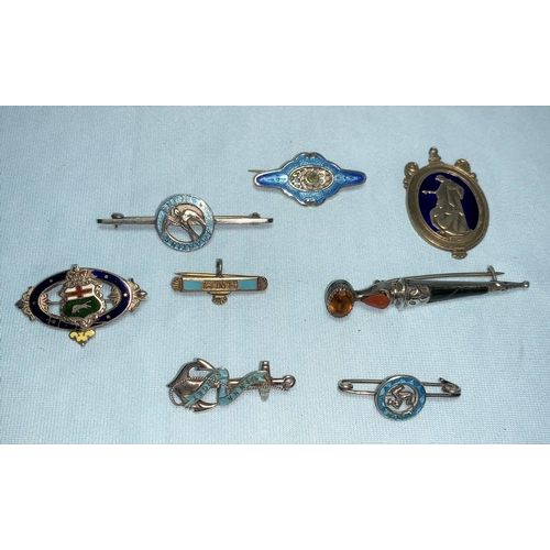 265 - A Scottish dirk brooch set citrine finial; an enamelled fob; 6 other enamelled brooches