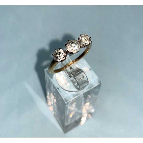 277 - A yellow metal ring set 3 diamonds, central stone .65 ct approx., gross diamond weight 1.5 ct approx... 