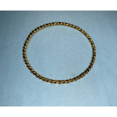 285 - An Egyptian yellow metal rope twist marriage bangle, bearing Egyptian hallmarks, tests as circa 22 c... 