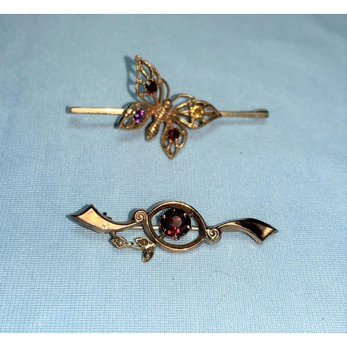 324 - A 9 carat gold bar brooch with stone set butterfly; another set garnet and seed pearls (both pins ba... 