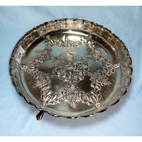329a - A silver circular fruit dish with scalloped edge and repousse decoration, raised on 3 paw feet, Birm... 