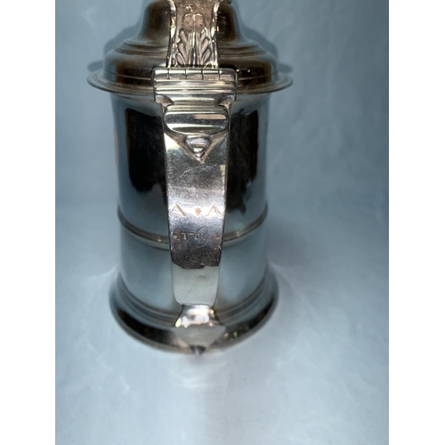365 - An early George III lidded silver tankard with tapering pedestal foot, the domed hinged cover with m... 