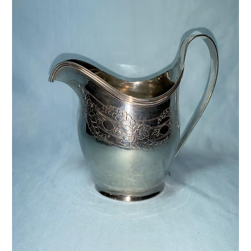 266 - A Georgian large silver cream jug with bright cut decoration of floral bands, ridge border and loop ... 