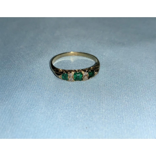 289 - A ladies 18 carat dress ring set 3 emeralds and 4 diamond chips, 3.3 gm, size S