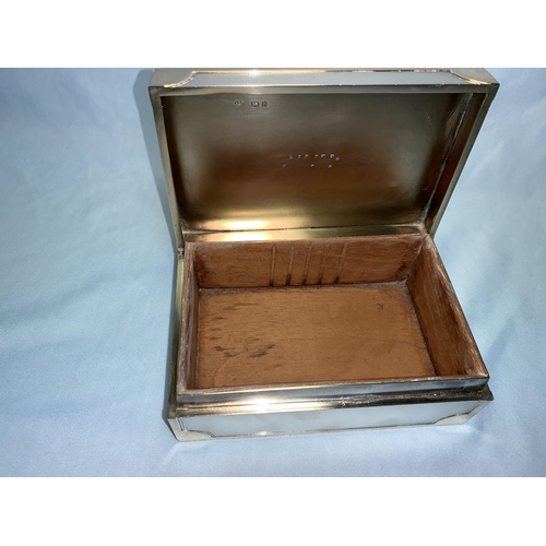339 - A hallmarked silver rectangular cigarette box with raised yellow metal mounts and monogram, hinged l... 