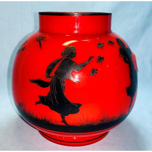192 - An early 20th century red glass vase with applied decoration of dancing girls, 15 cm