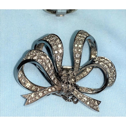 274 - A mid 20th century white metal bow brooch set with 120 diamonds, approx., 21 gm