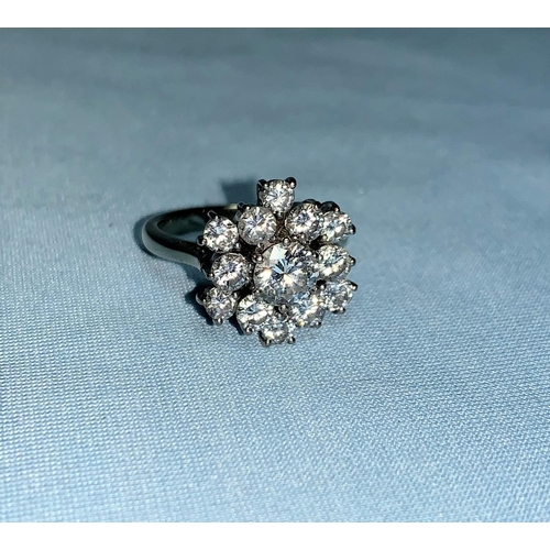 350 - A large white metal diamond cluster ring, set central stone of approx. 0.7 carat, surrounded by 12 s... 
