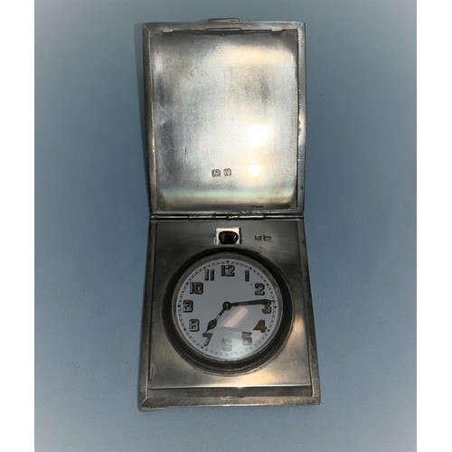 291 - An Art Deco travelling bedside clock in silver case, engine turned decoration, Birmingham 1923, 4.5 ... 