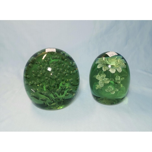 204 - A 19th century large green glass Dumpy with floral inclusion; a similar filled with bubbles, both 10... 
